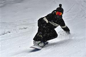 A snowboarder coming down the mountain